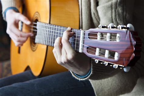 how to hold acoustic guitar (and delve into the nuances of acoustic guitar posture that go beyond the basics)